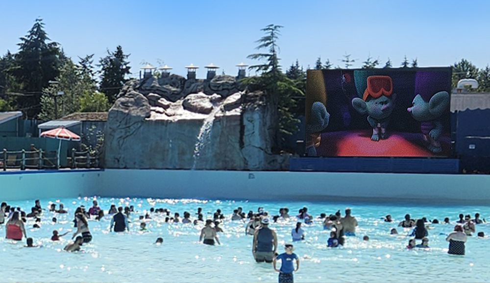 People watching a dive-in movie at the wave pool