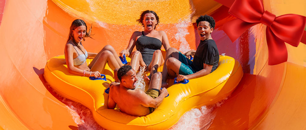 Family splashing down a water slide in a raft
